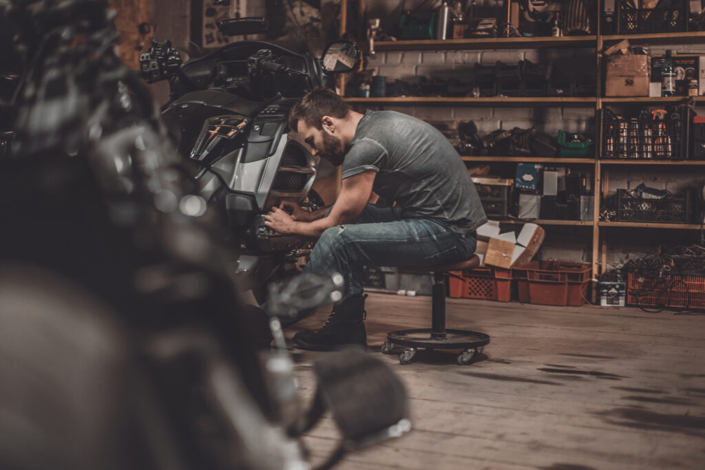 Spending Time With Bikes Confident Young Man Repairing Motorcycle Repair Shop Spending Time With Bikes Confident Young Man Repairing Motorcycle Repair Shop