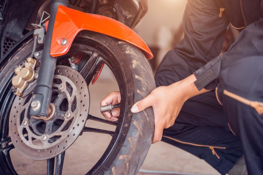 Motorcycle Repair Service Mechanic Is Pumping Tire Closeup 201922 72 Motorcycle Repair Service Mechanic Is Pumping Tire Closeup 201922 72